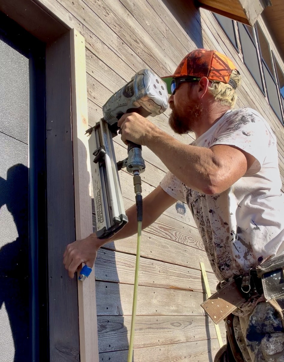 Nailing exterior window trim in Driggs, Idaho
