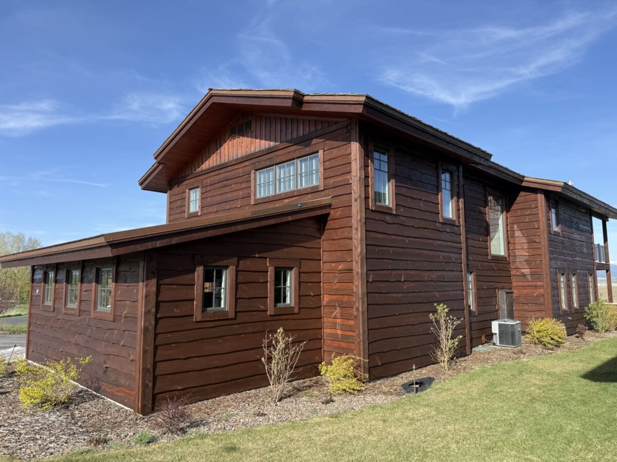 Exterior wood staining on a large timber home